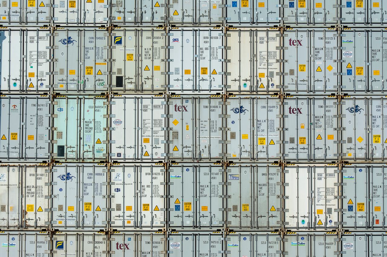 A patterned array of industrial shipping containers stacked in a storage terminal.